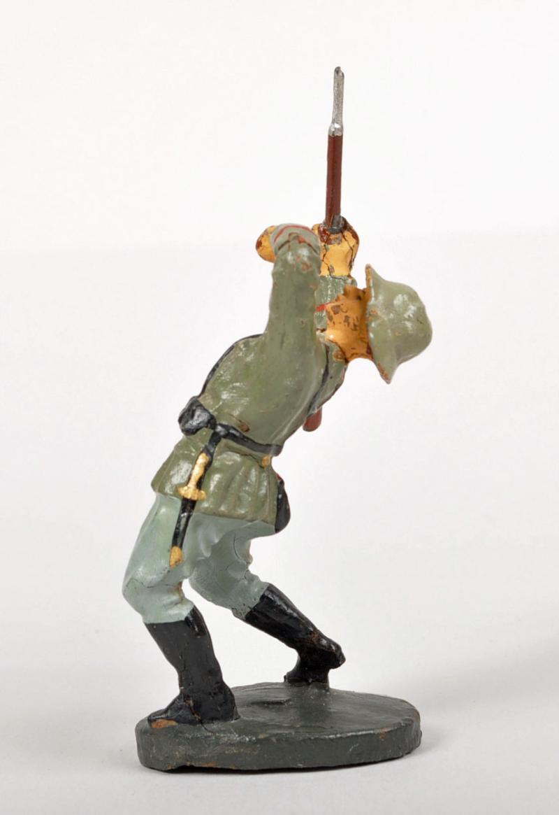 GERMAN WWII ELASTOLIN FIGURE OF A GERMAN SOLDIER BEING SHOT.
