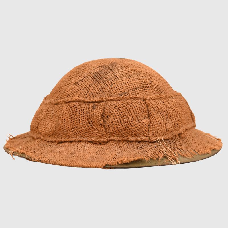 BRITISH WWI 1ST PATTERN BRODIE HELMET WITH A RARE TYPE OF SACKING COVER.