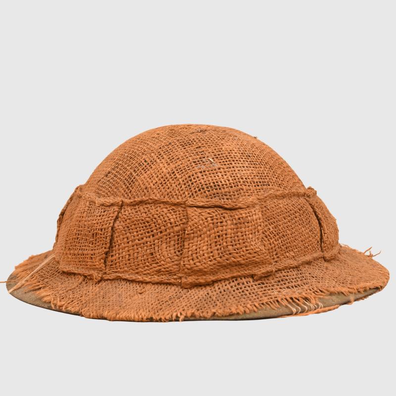 BRITISH WWI 1ST PATTERN BRODIE HELMET WITH A RARE TYPE OF SACKING COVER.