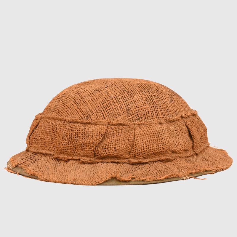 BRITISH WWI 1ST PATTERN BRODIE HELMET WITH A RARE TYPE OF SACKING COVER.