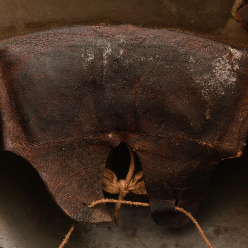 GERMAN WWI M.17 CAMOUFLAGE TRENCH HELMET WITH ORIGINAL CHINSTRAP AND LINER.