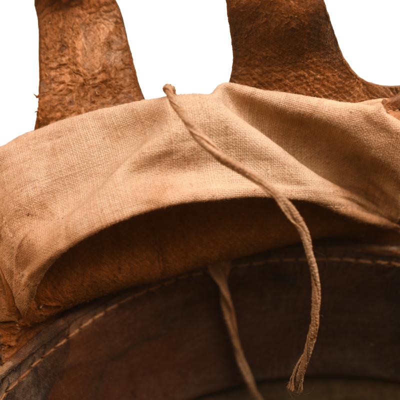 GERMAN WWI M.16 CAMOUFLAGE TRENCH HELMET WITH PARTIAL CHINSTRAP.