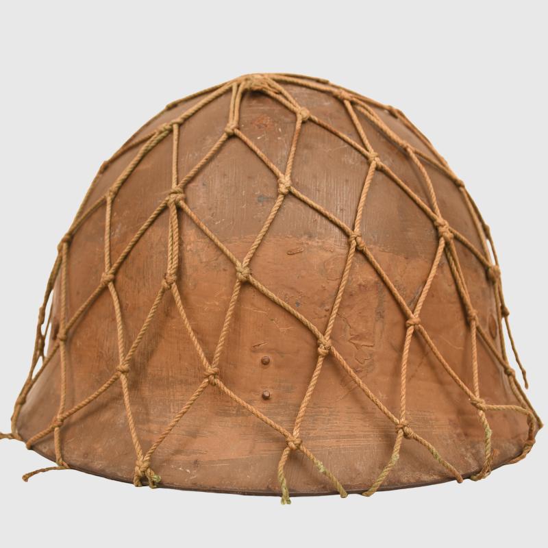 JAPANESE WWII TYPE 90 COMBAT HELMET WITH CAMOUFLAGE NET, IDENTIFIED TO AN INDIVIDUAL SOLDIER.