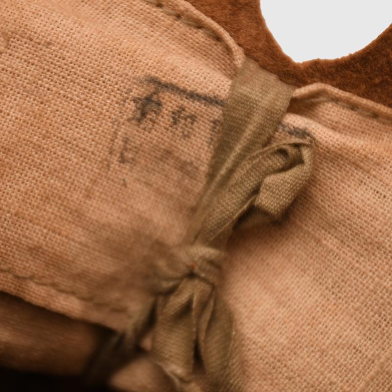JAPANESE WWII TYPE 90 COMBAT HELMET WITH CAMOUFLAGE NET, IDENTIFIED TO AN INDIVIDUAL SOLDIER.